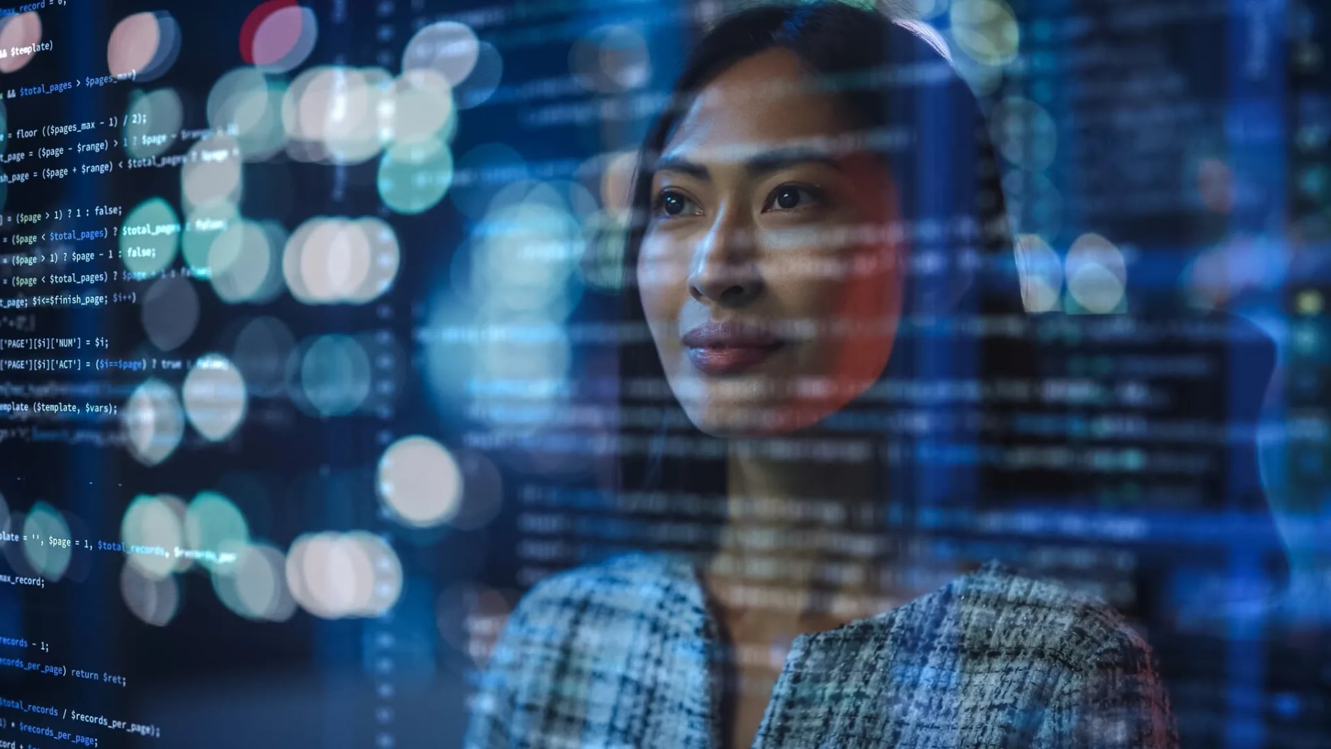 A female software developer thoughtfully analyzing glowing lines of code and data points on a transparent digital screen.